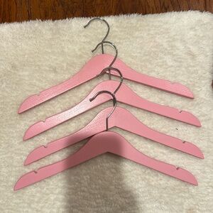 4 pink wooden kid hangers